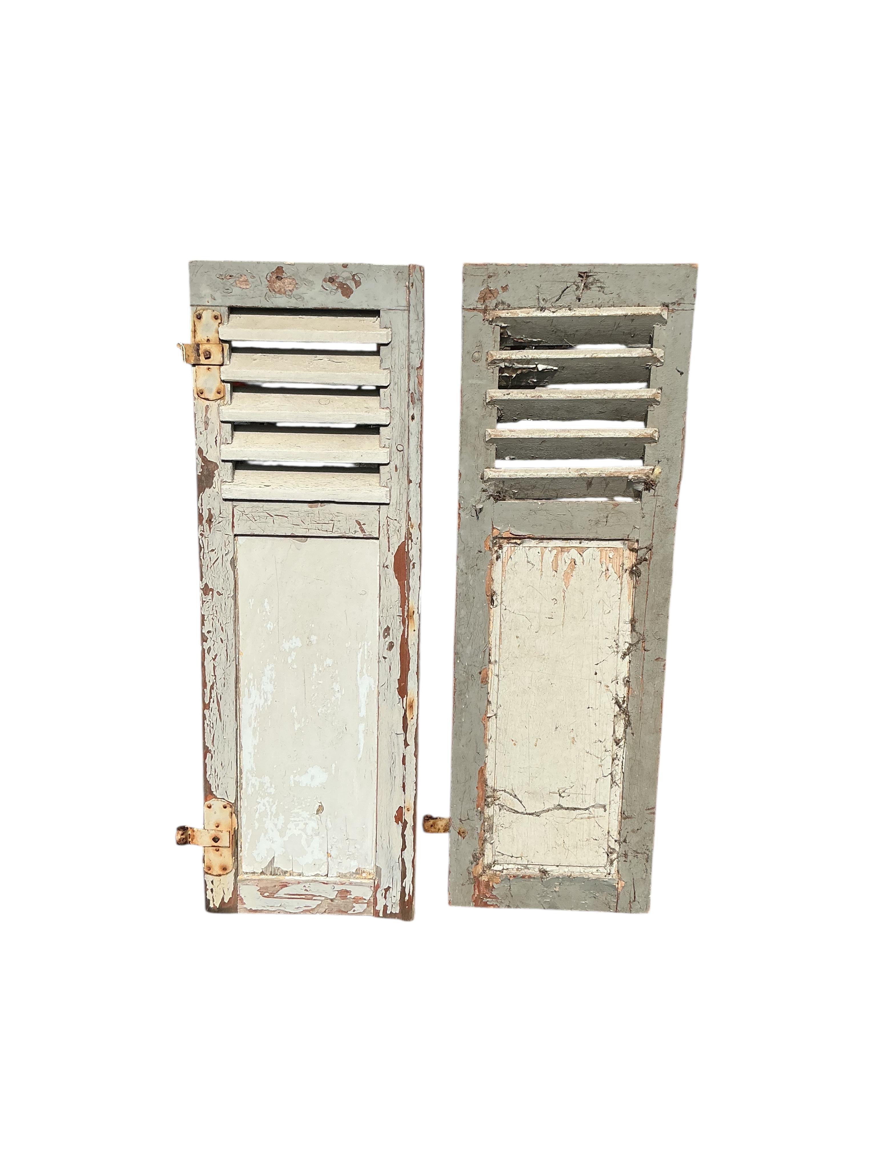 A pair of French painted wood window shutters, each width 43cm, height 130cm
